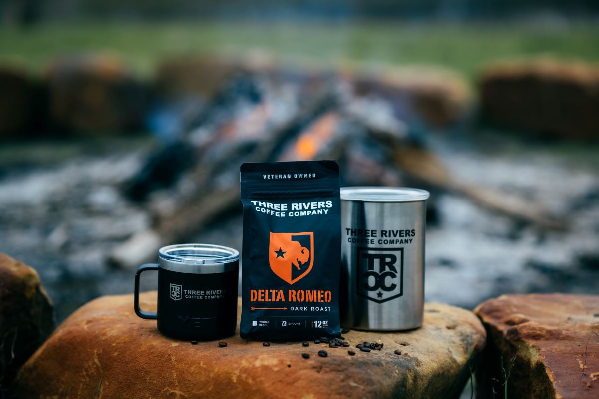 TRCC yeti Mug and coffee bag sitting on rock 